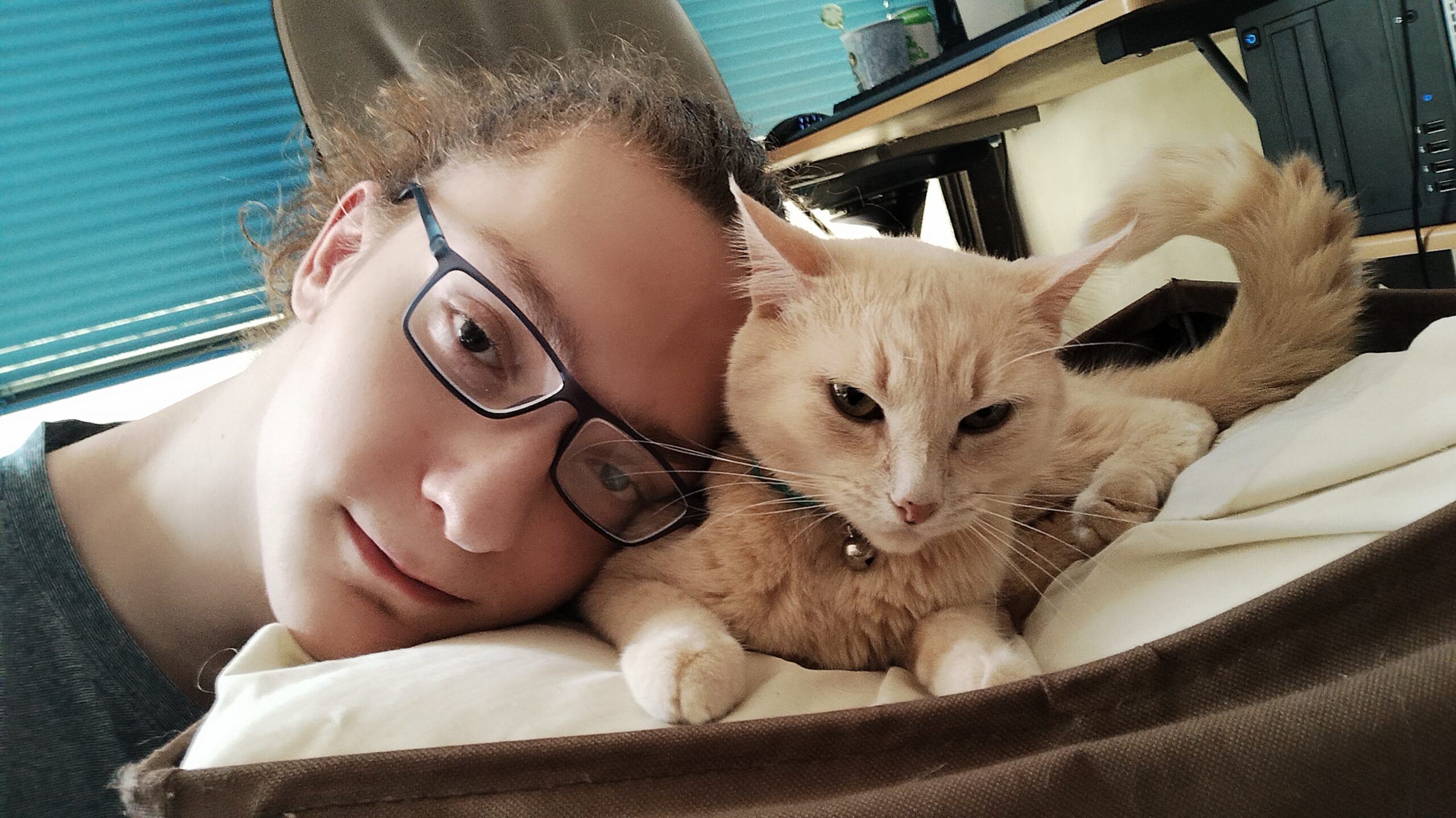 A photo of my face placed next to my cat.